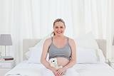 Pregnant woman with a cuddly toy