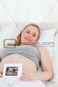 Delighted pregnant woman with her X-ray