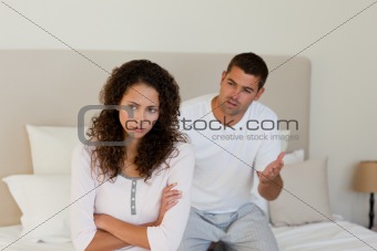 Young couple having a dispute on the bed