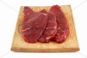 Three raw steaks