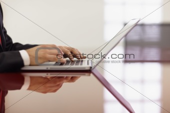 businessman typing on laptop computer