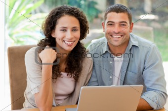 Lovers looking at their laptop at home