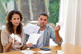 Pessimistic couple stressed with so many bills to pay