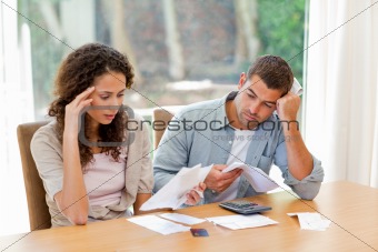 Young couple calculating their domestic bills
