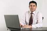 Indian businessman working on laptop