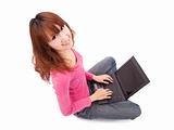 Asian young woman sitting on floor with a  laptop