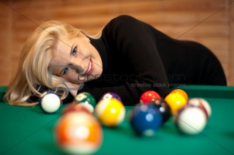 pretty female playing billiard
