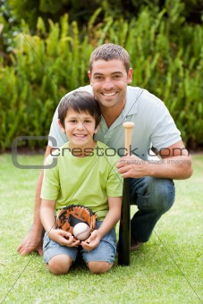 Happy father and his son playing baseball