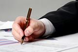 Male hand is writing in business document