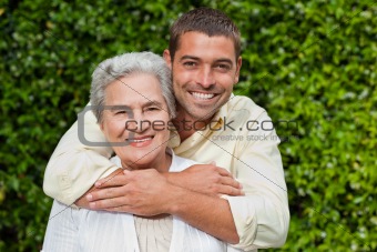 Man hugging his mother in the garden
