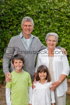 Grandparents with their children looking at the camera in the ga