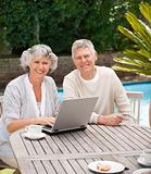 Retired couple working on their laptop