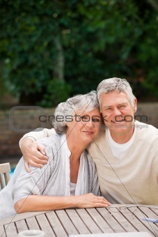 Senior couple hugging in the garden