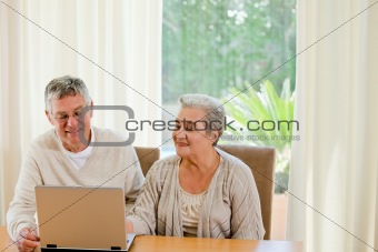 Senior couple looking at their laptop