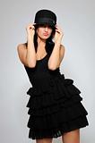 Beautiful fashion model in black dress with evening make-up