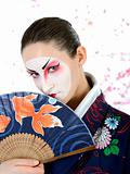  japan geisha woman with creative make-up with fan