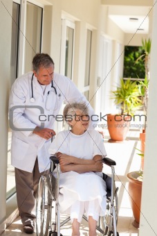 Senior doctor talking with his patient