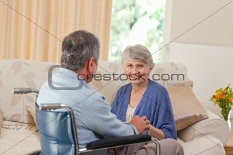 Senior couple talking in the living room at home