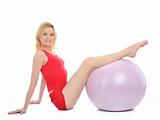 Pretty sporty fitness woman doing exercise with pilates ball.