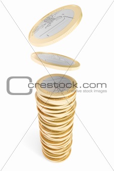 Euro coins falling on a coin pile