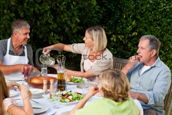 Lovely family eating in the garden