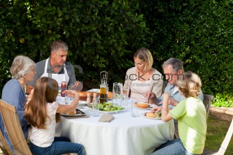 Adorable family eating in the garden
