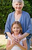 Grandmother with her granddaughter looking at the camera in the 