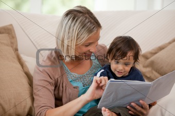 Mother looking at a book with her son