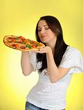 Pretty young casual girl with tasty pizza in delivery paper box.