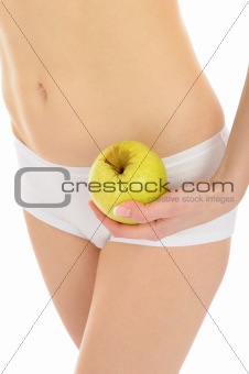 woman with beautiful body holding an apple near the slim waist. 