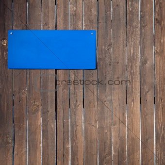 Wooden wall  with blue plate on it