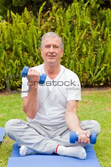 Senior man doing his exercises in the garden