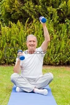 Retired man doing his exercises in the garden