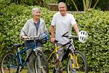 Mature couple walking with their bikes