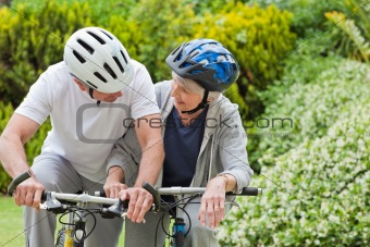 Mature couple mountain biking outside