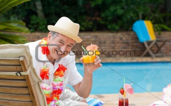 Mature man drinking a cocktail
