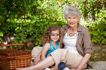 Grandmother with her granddaughter in the garden