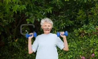 Mature woman doing her exercises in the garden