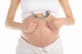 stomachs of pregnant women with a spoon and fork