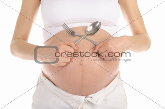 stomachs of pregnant women with a spoon and fork