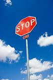 Stop sign with cloudy sky.