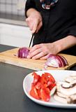 Woman Slicing a Red Onion