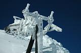 A ski lift covered with fresh snow looks like frozen