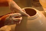 Potter's hands creating new ceramic vase