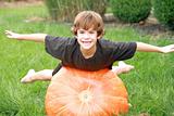 Boy Playing on Pumpkin