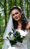 The nice young bride on a background of a birch wood