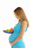 Pregnant  holding an apple and an orange in a pan