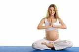 Pregnant woman practicing yoga, sitting
