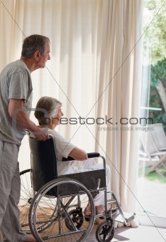 Retired couple looking out the window 