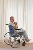 Smiling man in his wheelchair at home